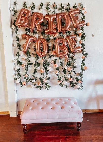 20 Simple Bride To Be Party Decoration Ideas At Home 2024 Photo Wall Bridal Shower Ideas, Diy Bridal Shower Photo Backdrop, Hens Party Photo Backdrop, Bridal Shower Decorations Backdrop, Hen Party Photo Wall, Simple Floral Bridal Shower Decor, Floral Bridal Shower Photo Backdrop, Photo Booth Bridal Shower Ideas, Hen Do Backdrop