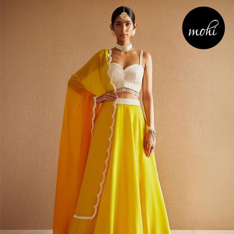 Elevate your style with our Pearl White embroidered blouse paired with a Sunny Yellow embroidered lehenga and a Shaded Yellow and Mustard embroidered dupatta! 🌼 Embrace the fusion of vibrant hues and intricate embroidery, perfect for adding a touch of elegance and charm to any celebration. . . . Outfit By : @harshitasinghviofficial Shop Now : www.mohifashion.com . . . . . #lehenga #lehengacholi #designerlehenga #weddinglehenga #lehengas #lehengainspiration #lehengagoals #lehengasmumbai #lehe... Celebration Outfit, White Embroidered Blouse, Embroidered Lehenga, Embroidered Dupatta, Wedding Lehenga, Sunny Yellow, Intricate Embroidery, Lehenga Choli, Embroidered Blouse