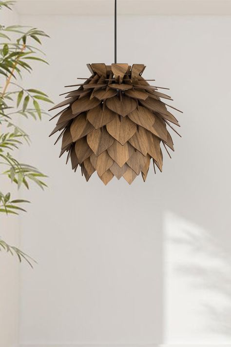 Transform your living space into a cozy haven with our exquisite wooden pinecone lamp. Crafted in a round, walnut hue, this lamp radiates rustic charm, making it the perfect centerpiece for any rustic-inspired decor. Embrace the allure of softly lit surroundings and experience the soothing ambiance it creates. Don't miss out on our bestseller, currently available at a 20% discount. Add a touch of natural elegance to your home today! 🌲✨ Pinecone Lamp, Pendant Light Dining Room, Light Dining Room, Lamp Wood, Round Ceiling, Wood Pendant Light, Charm Making, Wood Pendant, Chandelier Lamp