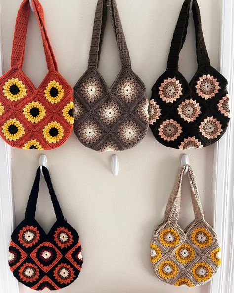 Autumn themed bags🍂, I seem to be in need of one more to add to my wall- any color suggestions?? 🤎🍁 Pattern is called sunburst granny… | Instagram Summer Brown Bags With Granny Square Details, Sunburst Granny Square Bag, Summer Granny Square Shoulder Bag, Crochet Sunburst Granny Square Bag, Yellow Granny Square Crochet Bag, Crochet Sunburst, Retro Granny Square Shoulder Bag, Sunburst Granny Square, Granny Square Bag