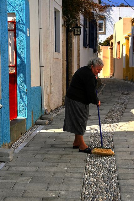 Serious cleaning...Koskinou, Rodos island, Dodecanese, Greece Sweeping The Floor, Elderly Woman Aesthetic, People Cleaning The Environment, Old People Traveling, Woman Cleaning House Photography, Greece Alleyway, Sweep The Floor, Photo Class, Image Bank