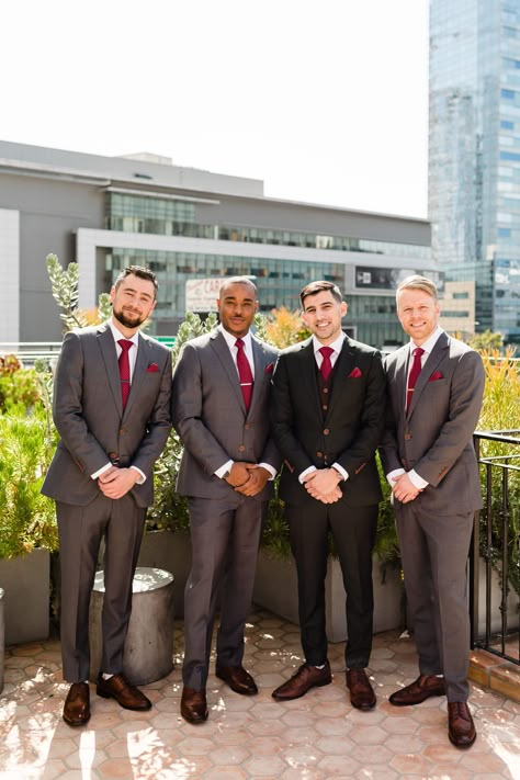 Groom with his groomsmen wearing dark grey suit and red tie getting ready for a spring wedding at Hotel Figueroa #colorfulweddingplanner #springwedding #downtownlosangeleswedding Groomsmen Attire Red Tie, Gray Suit Red Tie, Red Tie Outfit Men, Red Groomsmen Attire, Grey Suit Red Tie, Red Groomsmen, Black Suit Red Tie, Suit Red Tie, Suit With Red Tie