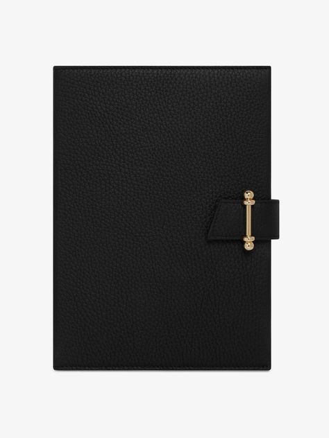 The ultimate office accessory, this stylish Strathberry Notebook is crafted from luxurious grain leather and features a gold-tone stamped logo. It opens up to lined pages made from high quality paper, which can be replaced with a new A5 refill pad when all your pages are complete. 100% Calf Leather. Soft microfibre lining. Gold hardware. Metal Stud. Closure Signature bar. Contains refillable A5 lined paper notebook. Depth: 2cm. Width: 16cm. Height: 22cm. Handmade in Spain. Luxury Leather-lined Office Cases, Luxury Notebook, Black Leather Rectangular Cases, Luxury Leather-lined Cases For Everyday Use, Black Leather Journal, Paper Notebook, Handbag Essentials, Leather Notebook, Office Accessories