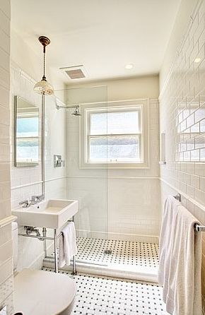 Gorgeous classic bathroom design with modern white porcelain sink with polished nickel base, white carrara marble basketweave tiles floor, glossy white subway tiles backsplash shower surround, open frameless glass shower and pendant. Classic Tile Combinations, 1890s Bathroom Tile, Subway Tile Master Bath, Tiny White Bathroom, Period Bath, Basketweave Tile Floor, Period Bathroom, England Cottage, Makeover Kamar Mandi