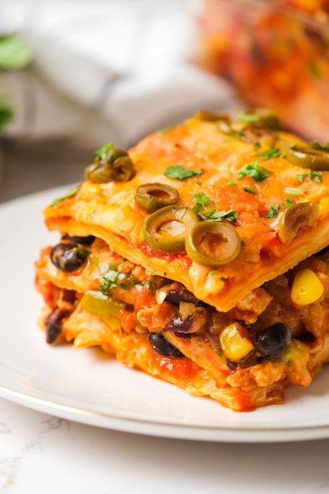 Loaded with meaty goodness, beans, corn, olives and more, Mexican Tortilla Lasagna is a tasty twist on the Italian classic! Mexican Lasagna With Tortillas, Tortilla Lasagna, Mexican Tortilla, Hispanic Recipes, Mexican Lasagna, Night Recipes, School Recipes, Mexican Casserole, Healthy School