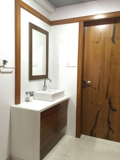 Minimalist designed Common ✨ Wash Basin Area incorporating Table Top Wash Basin with Wooden Vanity Unit below it, Rectangular Mirror above the Basin & A Wooden Frame denoting the Wash Basin Area - GharPedia Bathroom Table Top Basin, Counter Basin Design Ideas, Minimalist Washbasin, Wash Basin Storage, Tv Unit With Wash Basin, Wash Basin Counter Design Modern, Table Top Basin Counter Design, Table Top Wash Basin Ideas In Living Room, Tabletop Washbasin Design