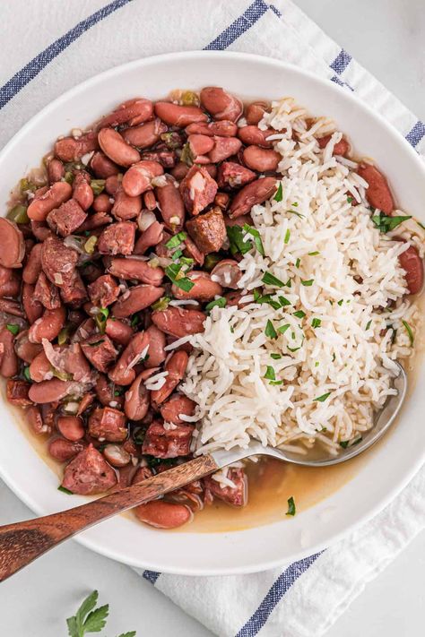 This BEST Red Beans and Rice Recipe is the Ultimate Cajun Favorite done right!  Insanely flavorful kidney beans with a hint of spice and meaty essence are served over white rice for the perfect Southern creole recipe.  Much better than Popeye's! #redbeans #kidneybeans #redbeansandrice #cajunrecipe