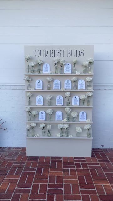 ASH BAUMGARTNER | Wedding Photographer on Instagram: "the cutest little seating chart @christinanikoledesigns @paeonina @honeysuckle.traditions @coreybourgeois @thehollinshouse #seatingchart #escortdisplay #weddinginspo #ourbestbuds #weddingdecor #weddingflowers #santacruzwedding" 75 Person Wedding Seating, Creative Seating Charts Wedding, Seating Chart Shelf Display, Seating Chart Fall Wedding, Candle Seating Chart, Seating Chart Wedding Flowers, Unique Wedding Seating Chart Ideas Fun, Seating Chart Garden Wedding, Cool Seating Chart