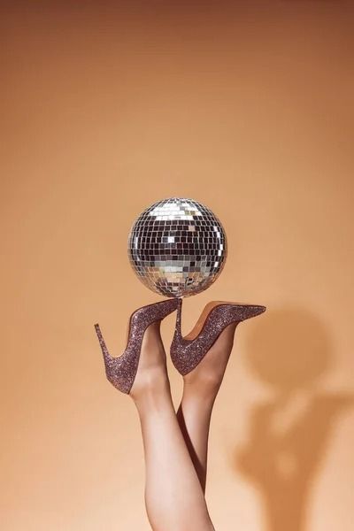 Cropped image of woman holding shiny disco ball on high heels at party on beige — effulgence, female - Stock Photo | #228179878 Photo Cropping, Crop Image, Female Images, Disco Ball, Branding Inspiration, Professional Photographer, Stock Images Free, Hold On, High Heels