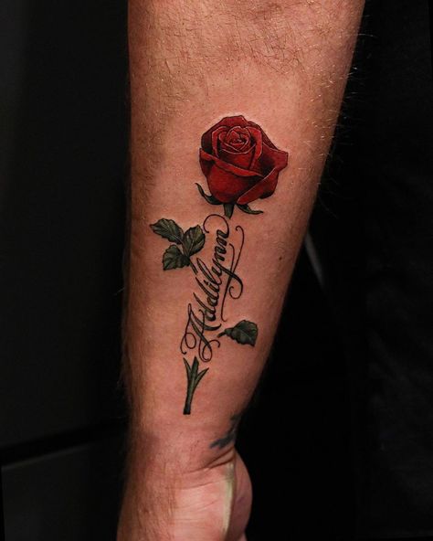 Hunter Schuon on Instagram: “Rose and some script from last night! Always enjoy tattooing flowers! To schedule a tattoo appointment please call or email…” Roses Around Name Tattoo, Red Roses Arm Tattoo, Red Rose Arm Tattoo, Tattoo Flower With Name, Roses With Names Tattoos, Red Rose Tattoo Men, Name With Rose Tattoo, Name Tattoos For Men, Red Roses Tattoo