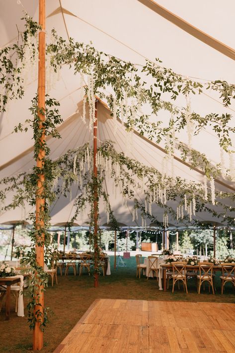 Wedding under sailcloth tent with hanging smilax vine greenery and white wisteria flowers Vintage Tent Wedding, Tent Engagement Decorations, Forest Tent Wedding, Whimsical Tent Wedding, Wildflower Tent Wedding, Spring Tent Wedding, Wedding Tent Diy, Wedding Tent Greenery, Wedding Tent Entrance