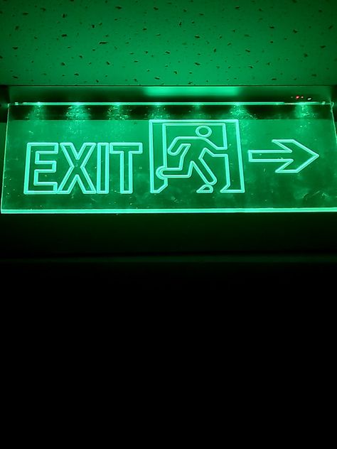 A neon green exit sign Exit Door Aesthetic, Neon Exit Sign, Exit Sign Aesthetic, Neon Green Sign, Green Y2k Aesthetic, Neon Green Aesthetic, Green Hour, Green Sign, Sci Fi Aesthetic