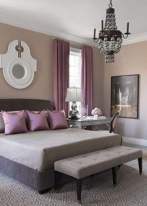 Purple and gray bedroom features walls painted warm gray lined with a dark gray bed dressed in gray bedding and purple pillows next to a gray desk as nightstand and purple round back topped with a silver double gourd lamp. Purple And Brown Bedroom, Purple And Gray Bedroom, Feature Wall Bedroom, Purple Bedrooms, Sophisticated Bedroom, Purple And Brown, Purple Bedroom, Transitional Bedroom, Casa Vintage