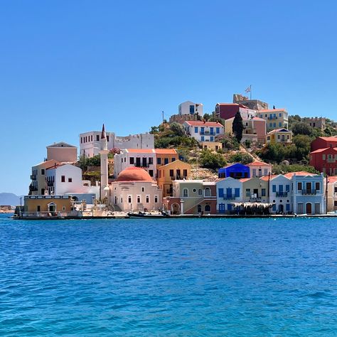 Kastellorizo/Megisti is a little known Greek island off the coast of Türkiye. You can catch a ferry for a day trip from Kaş, or there are other connections from other Greek islands I imagine. It is very small and we visited in the shoulder season so it had an authentic small town vibe. Very quiet and laid back, a lot of the locals were busy painting the buildings. We have visited 8 different Greek islands and this was the smallest, most local one, we loved the fact that it wasn’t on show fo... Greek Coast, European Seaside Town, Greek Town Aesthetic, Greek Village Aesthetic, Europe Small Towns, Greek Vibes, Busy Painting, Corfu Greece Old Town Pictures, English Essay