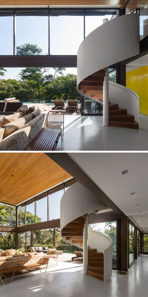 This white and wood modern spiral staircase is fully exposed in the interior and provides access to the second floor of the house. Outdoor Spiral Staircase, Staircase Modern, Spiral Stairs Design, Wood Stair Treads, Exterior Stairs, Stairs Architecture, Stairway Design, Stairs Design Modern, Wooden Staircases