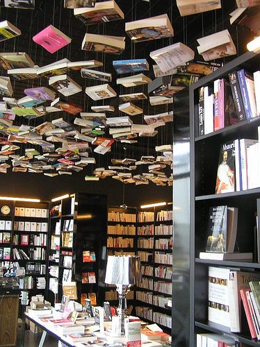 Floor to ceiling books! Hanging Books From Ceiling, Hanging Books, Luxury Home Library, Floating Ceiling, Bookstore Design, Library Cafe, Industrial Cafe, Bookstore Cafe, Ceiling Murals