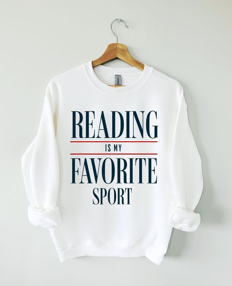 Hey Book lover, show off your love for Reading Books with our Reading is my favorite sport sweatshirt. The perfect gift for Readers, Librarians, Bookworms, Book Addicts, Book Nerds and Book Lovers.  All designs are available on tshirts/sweatshirts/hoodies. Send me a message if you can't find the product you need! MATERIAL ✨ Sweatshirt sizes are Unisex, please refer to sizing chart in listing photos ✨ 50% cotton, 50% polyester ✨ Medium fabric weight ✨ DTG Printed CARE ✨ Machine wash: warm (max 40 Book Nerd Sweatshirt, Book Lover Tshirt Design, Book Lover Shirt Ideas, Love Reading Quotes, Book Sweatshirts, Book Sweater, Reading Sweatshirt, Book Nerd Shirts, Book Clothes