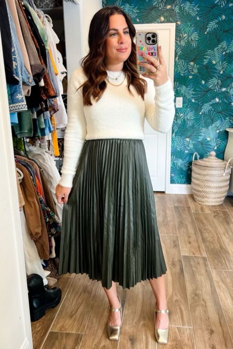 A fun twist on a pleated skirt outfit! This faux leather long pleated skirt from Amazon is affordable and stylish. If you’re wondering how to style it, simply pair it with a chic white sweater and trendy ballet flats. This cozy look is perfect for Thanksgiving, Christmas, and any other party you may have during the holiday season. Follow me for more winter outfit ideas! Holland Paterno. Pleated Skirt Outfit Green Skirt Holiday Outfit, Green Skirt White Top Outfit, Pleated Skirt Holiday Outfit, Pleated Skirt And Sweater Outfit, Amazon Christmas Outfits, Amazon Christmas Outfits Women, Pleated Skirt With Sweater, Pleated Skirt Fall Outfit, Pleated Skirt Outfit Winter