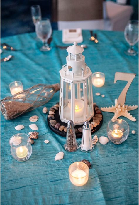 #nautical #centerpiece #lighthouse #simple #noflowers #beachwedding #messageinabottle Lighthouse Centerpiece Ideas, Lighthouse Theme Party, Lighthouse Centerpiece Wedding, Lighthouse Wedding Centerpieces, Lighthouse Party Theme, Lighthouse Table Centerpiece, Lighthouse Lantern Centerpiece, Lighthouse Wedding Theme, Nautical Candle Centerpieces