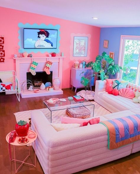 A dopamine decor living room with a bold pink and periwinkle accent wall, a fireplace, a sectional, colorful pillows and blankets and bold decor Cotton Candy Living Room, Pastel Coffee Table, College Dorm Inspo, College Dorm Ideas, Pastel Apartment, Nyc Decor, Candy Room, Pastel Living Room, Colorful Apartment