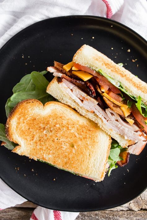 This turkey BLT sandwich with cheese is the perfect back-to-school sandwich. It combines lightly toasted bread with homemade garlic basil mayonnaise, sliced turkey, sharp cheddar cheese, crispy bacon, sliced tomato, and baby arugula. Turkey Blt Sandwich, Basil Mayonnaise, School Sandwich, Toasted Turkey, Turkey Blt, Daemon Black, Grilled Sandwiches, Blt Sandwich, Turkey Cheese