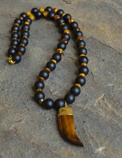 12mm matte black onyx, faceted tiger's eye rondelles and 12mm faceted tiger's eye beads. Bracelet is approximately 8" in length and has a gold lobster clasp. Customization available upon request. Coordinating necklace is sold separately. Every item sold plants a tree through our partnership with One Tree Planted. Men Tiger Eye Necklace, Tigers Eye Bracelet, Mens Beaded Necklaces, Lava Rock Bracelet, Latest Bracelets, Rock Necklace, Tigers Eye Necklace, Black Onyx Necklace, Black Tigers