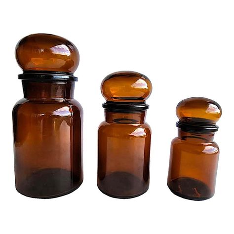 Offered is a set of three vintage Belgian glass apothecary bottles with mushroom top stoppers. The stoppers have rubber bases and around the lower edge to close the bottles tightly and avoid contamination. While these may have been used in apothecary stores, they are also lovely for use in the kitchen to store spices, teas, and coffee.   They measure Large 3.75" diameter, bottle is 6.5" tall, with stopper 8.5" tall Medium 3.25" diameter, bottle is 5.25" tall, with stopper 7" tall Small 2.75" dia Apothecary Bathroom, Cottage Core Kitchen, Applique Art Deco, Apothecary Design, Apothecary Pharmacy, Apothecary Decor, Bathroom Canisters, Brown Bottles, Glass Spice Jars