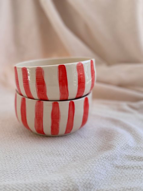 Indulge in the luxury of Mediterranean summers with our Striped Bowl. Handcrafted with white clay and detailed with hand-painted red stripes, these bowls are the perfect addition to your summer table. Enjoy a fresh salad or a refreshing fruit mix and transport yourself to a breezy seaside escape. •1 per order •each piece is handmade and will have slight variations to another. • dishwasher safe, however handwashing is recommended for best care. Hand Painted Dinnerware, Ceramic Bowls Handmade, Ceramics Bowls, Painted Bowls, Ceramics Bowls Designs, Striped Bowl, Bowl Pottery, Hand Painted Bowls, Camping Aesthetic