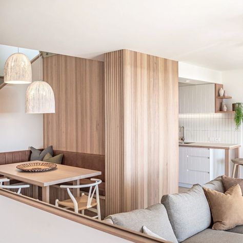 So much to love about the transformation of @noosa.penthouse37 ! Beautiful timber panelling envelopes the dining area and wraps around to the living area adding natural warmth, texture and variation. Repost: @noosa.penthouse37 Design: @renegade_design_studio Build: @captivate_constructions Photography: @emmabournephotography Product: Porta Contours, Cirque #interiordesignideas #interiordesignlivingroom #interiordesignideasforsmallspaces Timber Feature Wall, Curved Kitchen Island, Timber Battens, Kitchen Island Bench, Timber Panelling, Beautiful Cabinet, Kitchen Design Trends, Stunning Kitchens, Dining Nook