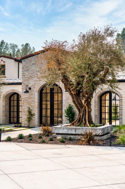 Modern Spanish Home Exterior Mediterranean Design, Mediterranean Home Entrance, Ranch Mediterranean Homes, Medditeranean Front Door, Santa Barbara Modern Home, Mediterranean Stone House Exterior, Mediterranean Brick House Exterior, Mediterranean Front Entrance, Cottage Entrance Exterior