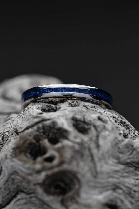 A thin titanium wedding band with a lapis lazuli inlay. The ring is setting atop a piece of gray driftwood. Fit At Home, Engagement And Wedding Rings, Titanium Ring, Wide Ring, Wide Rings, Making Waves, Titanium Rings, Inner Peace, Positive Energy