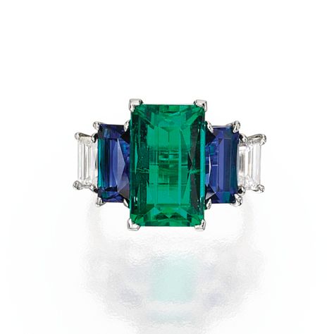 PLATINUM, EMERALD, SAPPHIRE AND DIAMOND RING. Centered by a rectangular step-cut emerald weighing 7.09 carats, flanked by two rectangular step-cut sapphires weighing 2.01 and 1.91 carats, further accented by two baguette diamonds weighing approximately .90 carat, size 6. Bijoux Art Nouveau, Sapphire And Diamond Ring, Emerald Engagement, Emerald Jewelry, Art Deco Ring, Gems Jewelry, Love Ring, Dream Jewelry, Emerald Ring