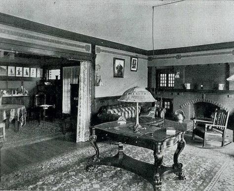 Bungalow Living Room Portiere, brick fireplace, painted or wallpaper frieze The cord for the lamp on the table in the middle of the room was run across the ceiling. From the Jud Yoho Houseplans book, 1920. Brick Fireplace Painted, Wallpaper Frieze, 1920s Living Room, Fireplace Bench, Fireplace Painted, French Country Crafts, Historic Home Interiors, 1920s Craftsman, Bungalow Living Room