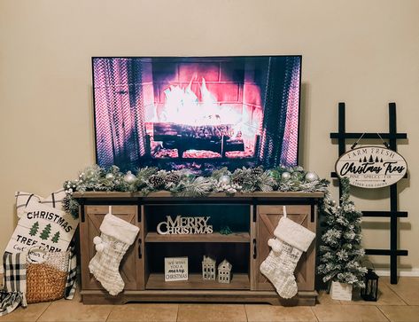 Christmas Decor Under Tv Stand, Christmas Living Room Tv Stand, Under The Tv Christmas Decor, Christmas Decorations For Tv Stand, Entertainment Stand Christmas Decor, Tv Fireplace Christmas Decor, Christmas Tv Unit, Decorating Tv Stand For Christmas, Entertainment Center Christmas Ideas