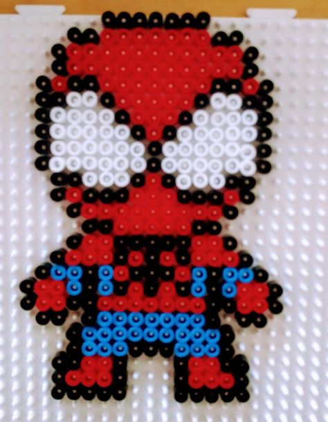 Spiderman beads #perleshama Peeler Bead Spiderman, Spiderman Beads Pattern, Perler Beads Ideas Spiderman, Pyssla Ideas Spiderman, Spiderman Melty Beads, Spiderman Bead Pattern, Iron Beads Spiderman, Spiderman Pearl Beads, Spider Man Perler Bead Pattern