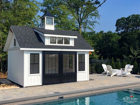 A pool house can complete your backyard escape. Our pool houses are available in farmhouse style, as pictured here, and can even come with a painted interior. This is a 12' x 16' Modern Farmhouse Carriage House with 8' split sliding doors, vinyl board & batten siding, and 3-window farmhouse transom dormer. Get in touch with us today to begin planning for your farmhouse style pool house, exclusively at The Barn Yard. Tuff Shed Pool House, Small Pool House With Bathroom, Small Pool Houses Sheds, Small Pool House Interior, Shed Pool House Ideas, Small Pool Shed, She Shed Pool House, Farmhouse Carriage House, Small Pool House Plans