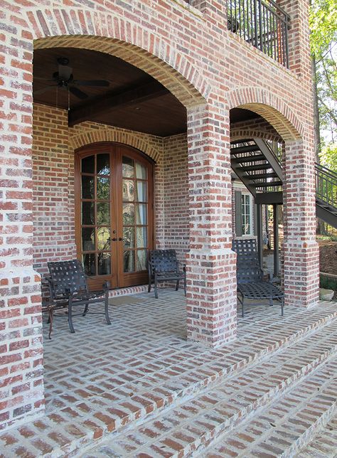 Arches and columns bring light and air into this backyard oasis. Brick stairs built with mortared pavers in a basket-weave pattern give the patio an extra touch of elegance. http://insistonbrick.com/ Exterior Brick House Colors, Brick Paint Colors, Brick House Colors, House Columns, Brick Porch, Brick Companies, Brick Columns, Brick Arch, Red Brick House