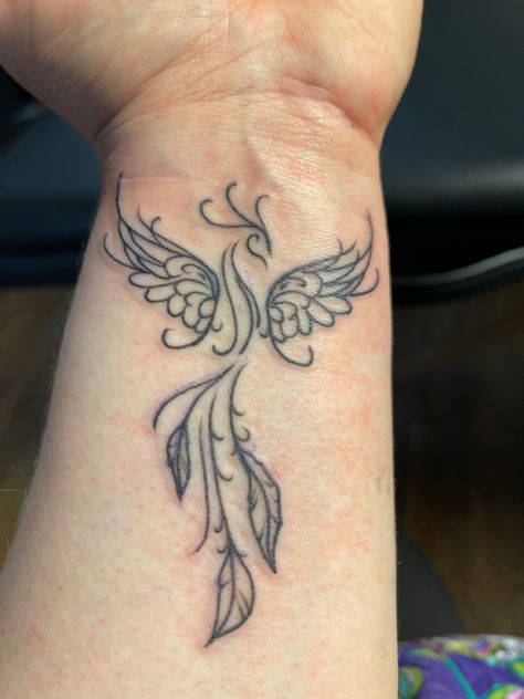 Phoenix tat on wrist Phoenix Tattoo Wrist Feminine, Phoenix Tattoo On Wrist, Phoenix Foot Tattoo, Phoenix Tattoo Wrist, Women’s Wrist Tattoos, Phoenix Wrist Tattoo, Pheonix Tattoo Ideas Female, Small Phoenix Tattoos For Women, Tiny Phoenix Tattoo