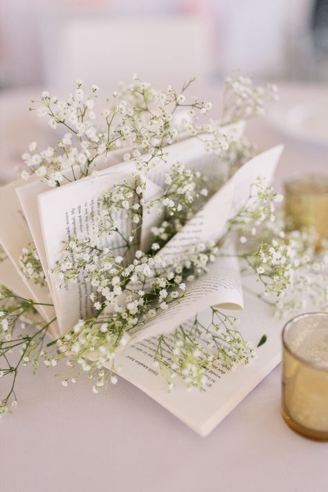 Use books for centerpieces for a unique personal touch at your reception! | Photography by Emma Farr Photography Book Decor For Wedding, Guest Book Table Flower Arrangement, Book Bridal Shower Theme Centerpieces, Unique Graduation Centerpieces, Book Themed Wedding Centerpieces, Book Page Centerpieces, Book Themed Wedding Shower Ideas, Book Lover Wedding Ideas, Wedding Book Decor