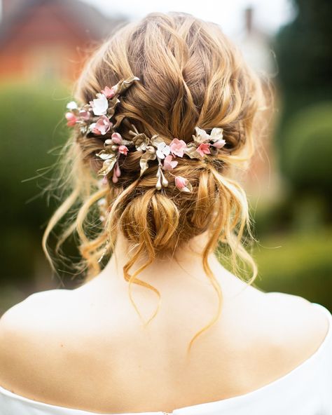 Messy Bun With Flowers Wedding, Textured Wedding Hairstyles, Bridal Whimsical Hair, Boho Wedding Bun Hairstyles, Messy Bun Flowers, Boho Bridal Updo With Flowers, Low Bun Wedding Hair Flowers, Wedding Hair Relaxed, Wildflower Wedding Hair Updo