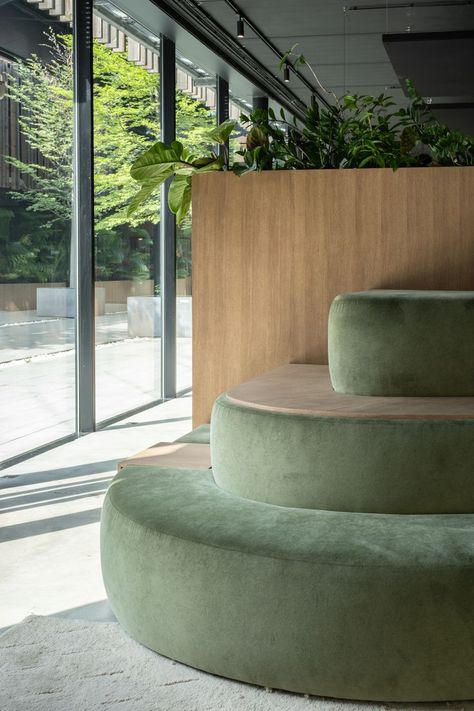 #architecture #interiorarchitecture #office #furniture #couch #green #industrial #velvet #plants #wood #concrete Green Accent Interior Design, Wood Concrete Interior, Green Office Space, Platform Seating, Green Workspace, Coworking Furniture, Concrete Lounge, Green Office Design, Reception Area Design