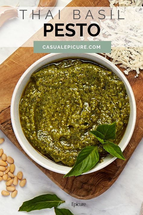 This Thai Basil Pesto combines the distinctive flavor of Thai basil with traditional pesto ingredients for a bold, flavorful sauce. Whether drizzling it over noodles, spreading it on sandwiches, or using it as a dip, this versatile pesto adds a vibrant Thai twist to any dish. Thai Basil Pesto, Marinades For Chicken, Classic Pesto Recipe, Italian Gravy, Toasted Rice, Nut Free Pesto, Sandwiches And Wraps, Make Pesto, Assorted Nuts