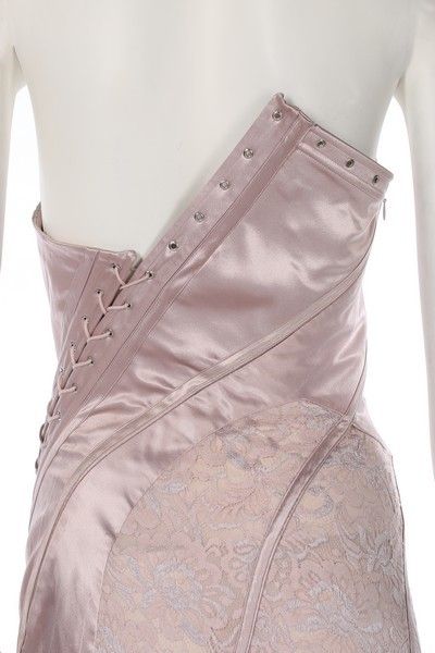 A John Galliano pink satin and lace gown, Spring-Summer 2000, labelled and UK size 12, the asymmetric corset-like bodice with diagonal lacing which continues down through the fish-tail skirt, bust 92cm, 36in, waist 66cm, 26in    This was look no. 12 on the catwalk. Bella Hadid wore an identical gown to the Bulgari perfume launch in Rome, 24th May 2017. John Galliano Corset, Corset Runway, Bulgari Perfume, Asymmetrical Corset, Corsets Fashion, Corset Lacing, Corset Design, Collection Couture, Corset Skirt