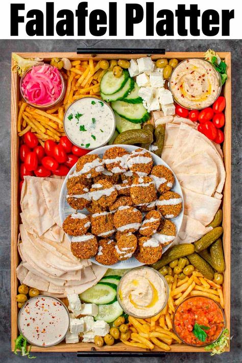 Need more falafel platter ideas? Search no more with this recipe for an EPIC falafel platter. With lots of mezze style goodies, hummus, baba ganoush, pickled vegetables, pita bread, and fries, this is the ultimate party dish for entertaining. Falafel Charcuterie Board, Falafel Platter Ideas, Shawarma Platter Ideas, Falafel Ideas, Falafel Platter, Lebanese Dinner, Greek Meat, Tapas Ideas, Graze Board