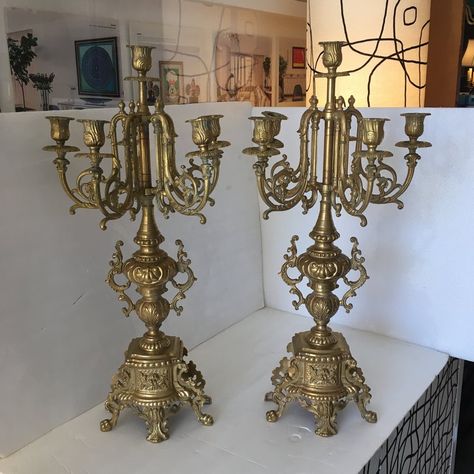 Beautiful pair of ornate European candle holders or tabletop candelabra made of solid metal with a gold finish. They are impressive in size, stature, weight and look. They have a bold presence. There is a lot of detail on these candle holders and they can work with a traditional decor and perfect for an eclectic look notably of the gypset and the boho chic look. One candle socket is bent inward but does not detract from the beauty of these pieces. Brass Candelabra Decor, Candleabras Dining Table, Ornate Candle Holder, Vintage Event Decor, Candlebra Decor Ideas, Candle Abras, Living Room Antique Decor, Fairytale Candle, Versailles Decor