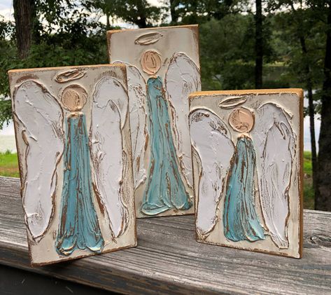 Beautiful handmade, hand painted, textured angels come in a set of three varying sizes: 6x8, 6x10, and 6x12. Background is ivory, and angels are in blue gowns. Makes a striking display for mantle, table, or entry. Sold individually. Artist signature and company name are included on the back. Because each design is individually drawn, painted, and textured, each piece is unique and will vary slightly. Blue Gowns, Artist Signature, Blue Gown, Artist Signatures, Pitcairn Islands, Papua New Guinea, Guinea Bissau, British Indian Ocean Territory, Wood Blocks