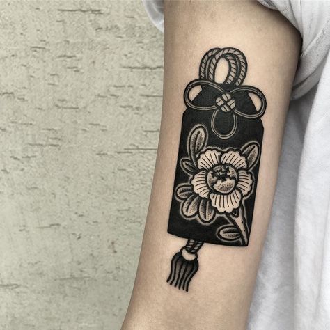 Omamori & Peony . Done at @hanatattoostudio  Thanks a lot @cuuurlytops . 📧madamlee.art@gmail.com Omamori Tattoo Design, Omamori Tattoo, Charm Bracelet Tattoo, Charm Tattoo, Bracelet Tattoo, Fan Tattoo, Type Tattoo, Marquesan Tattoos, Fire Tattoo