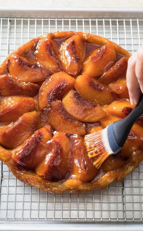 Peach Tarte Tatin: We use peaches for a summery tarte tatin, which requires some adjustments for this sweeter, more fragile fruit. To make a finishing glaze for the tarte, we reduce reserved peach juice with bourbon until dark and syrupy. Peach Tarte Tatin Recipe, Peach Tart Tatin, Peach Tart Recipes, Tart Tatin, Tarte Tatin Recipe, Fancy Foods, Diner Food, Peach Tart, Peach Recipes