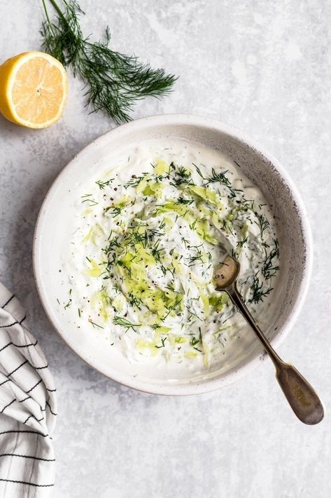 This easy homemade tzatziki recipe is a healthy Greek inspired sauce also known as yogurt cucumber sauce. Made with creamy greek yogurt, fresh lemon juice, garlic, shredded cucumber and fresh dill. Perfect for serving on greek kabobs, gyros, greek salads or with pita chips or carrot sticks for dipping! #tzatzikisauce #greekfood #greekyogurt #highprotein #healthysnack #diprecipe Greek Kabobs, Shredded Cucumber, Tzatziki Dip, Easy Homemade Salad Dressing, Salat Wraps, Easy Salad Dressing Recipes, Greek Chickpea Salad, Cucumber Sauce, Tzatziki Sauce Recipe