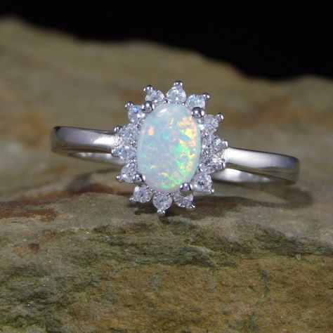 The Princess is our lab-created White Opal Ring. This gorgeous solid sterling silver ring features a gorgeous oval white opal (lab created) surround by a halo of 1 mm CZs. The rest of the band is polished sterling silver. The opal is gorgeous & full of fire! This ring would make a beautiful promise or engagement ring. Absolutely stunning in person!!! ~Metal : .925 Sterling Silver ~Metal Stamp: .925 ~Face Height: approx. 7 mm ~Center Gem: White Opal ~Center Gem Shape: Oval surround by a halo of 1 Jewelry Cartier, White Opal Ring, Silver Ring Designs, Princess Ring, Gold Diamond Wedding Band, Onyx Necklace, Morganite Engagement Ring, Jewelry Model, Silver Engagement Rings